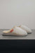 Side View of Alys Eco Sheepskin Slippers on Concrete Surface