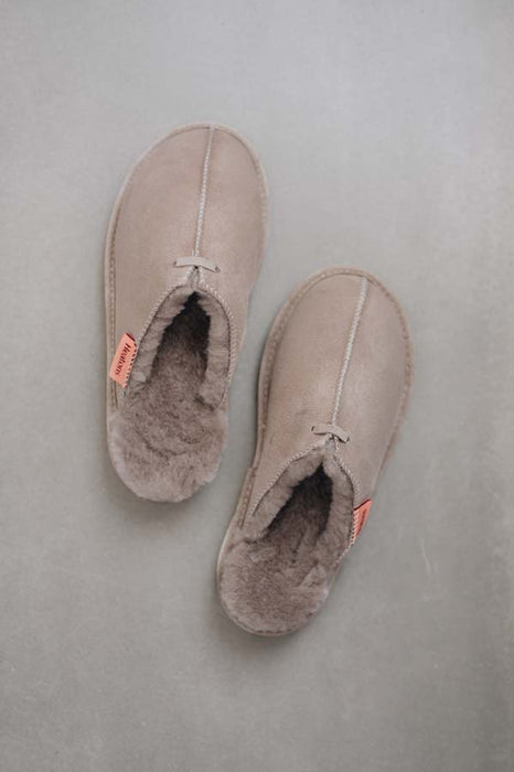 Birds Eye View of Alys Stone Sheepskin Slippers on Concrete Surface