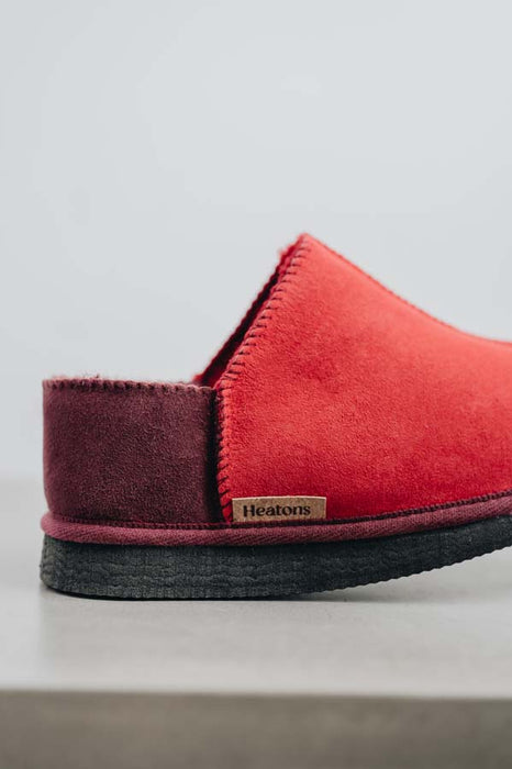 Close up View of Cadi Red Sheepskin Slippers with Heatons label detail on Concrete Surface
