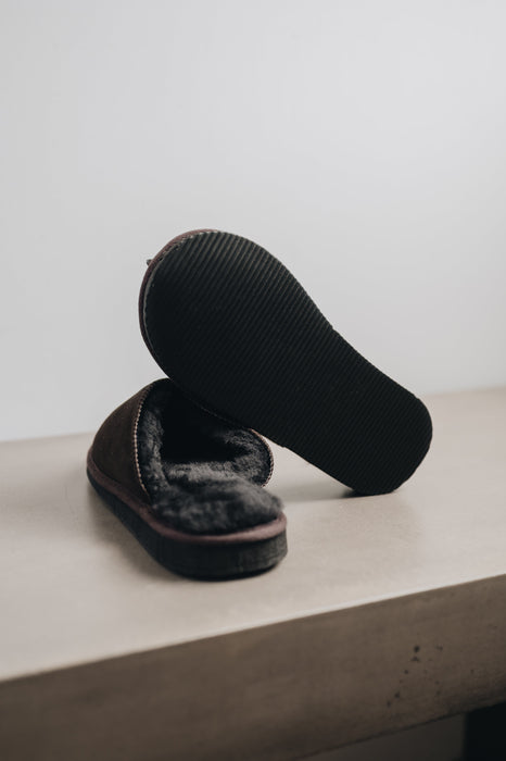 Dark brown merino sheepskin men's mule slippers with a black PVA hard sole
