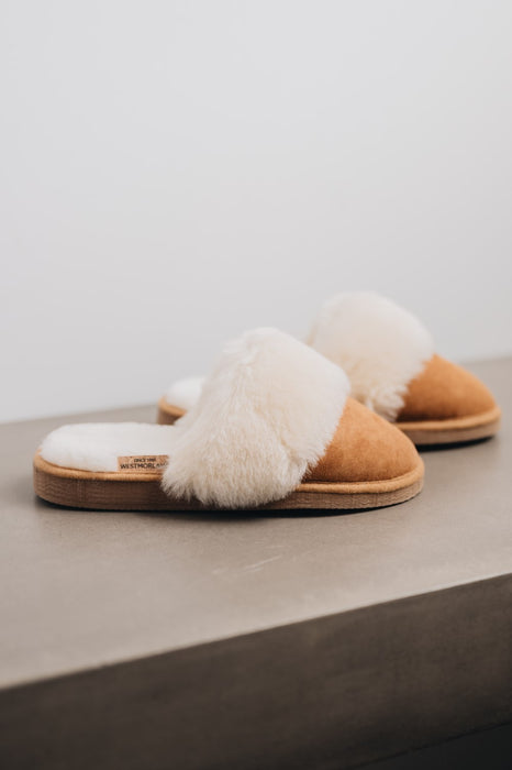 Side view of Veronica Mel Sheepskin Slippers on Concrete Surface