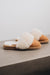 Side view of Veronica Mel Sheepskin Slippers on Concrete Surface