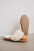 Veronica Mel Sheepskin Slippers showing the bottom of the EVA sole on a Concrete Surface