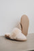 Veronica Vanilla Sheepskin Slippers showing the bottom of the EVA sole on a Concrete Surface