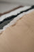 Close-up of a the rubber non
-slip underside of an oatmeal coloured sheepskin pet bed