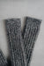 Ribbed brown natural merino wool sock on a light grey background - detail of ribbed sock neck