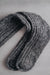 Ribbed brown natural merino wool sock on a light grey background - detail of ribbed sock and toe post