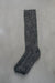 Brown natural merino wool sock on a light grey background