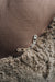 Close-up of a zipper on a brown fabric surface that is the bottom of a sheepskin beanbag.