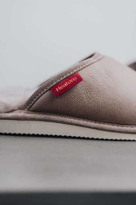 Close up View of Idris Walnut Sheepskin Slippers with Heatons label detail on Concrete Surface