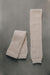 Pair of beige knitted wool leg warmers on a gray background- 