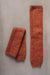 Pair of brown knitted wool leg warmers on a gray background
