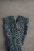 Pair of gray knitted wool bed socks on a gray background