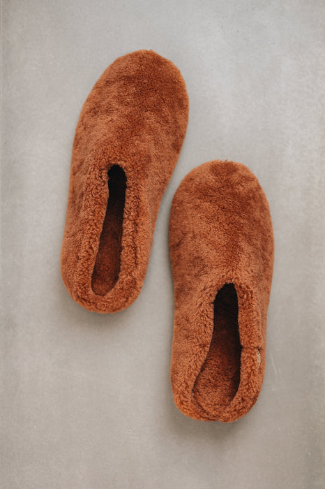 Curly merino sheepskin slip on slipper with curls on the outside and inside in a rich, warm rust colour.