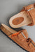 birds eye view of the metal buckle of the sandal