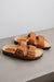 high angle of the sandals and their metal buckle