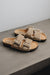 High angle of the vanilla mead slippers with metal buckles and a vanilla sheep skin with sheep wool on the inside