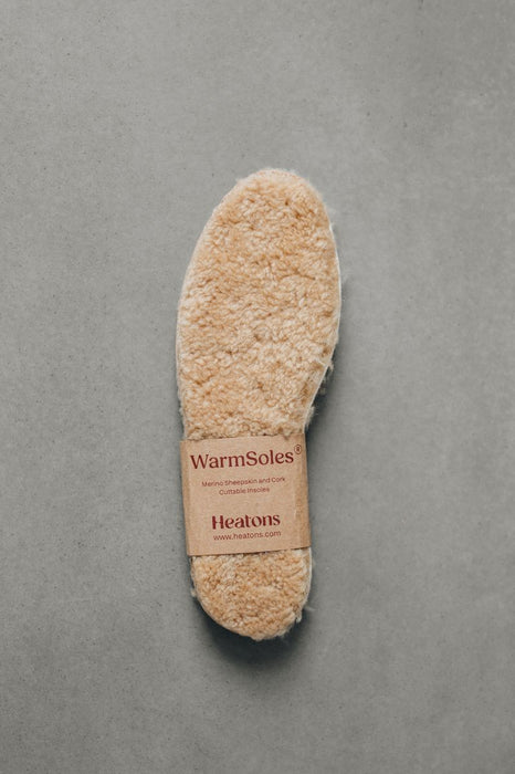 WarmSoles sheepskin footbed on a gray background