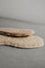 Pair of beige shoe sheepskin inserts on a gray background