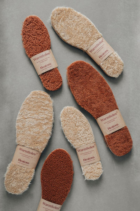 Pairs of Sheepskin insoles on a gray background WarmSoles