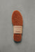 Brown curly Sheepskin  insoles with WarmSoles label on a gray background