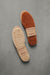 Two pairs of WarmSoles sheepskin insoles on a gray background
