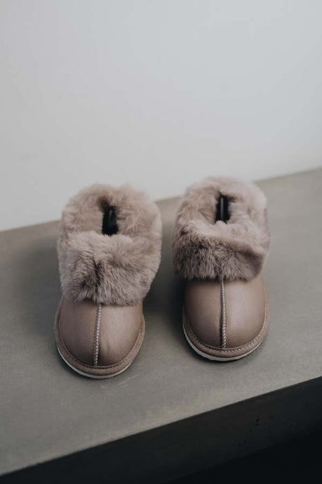 Front view of Ruby Walnut Sheepskin Slippers with Heatons label detail on Concrete Surface