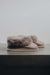 Side View of Ruby Walnut Sheepskin Slippers on Concrete Surface