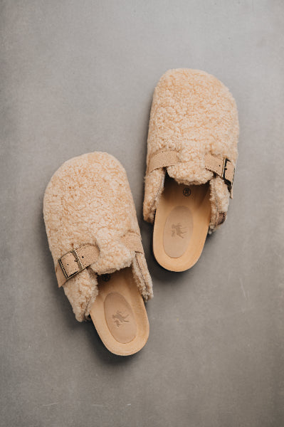 Birds eye view of curly sheepskin mule with adjustable strap 