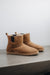 Side view of the Sheepskin, Chelsea boot style, slipper. A classic sheepskin boot with elastic panels on both sides.