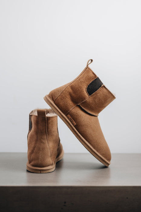 Heel and side view of the Winnie Sheepskin, Chelsea boot style, slipper. A classic sheepskin boot with elastic panels on both sides.