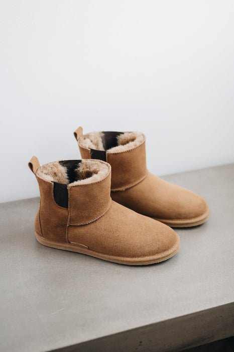 Top and side view of the Winnie Sheepskin, Chelsea boot style, slipper. A classic sheepskin boot with elastic panels on both sides.