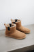 Top and side view of the Winnie Sheepskin, Chelsea boot style, slipper. A classic sheepskin boot with elastic panels on both sides.