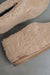 Side view of a camel coloured curly merino sheepskin boot slipper with natural cork Heatons brand label