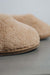 Close up of the toe post of a camel coloured curly merino sheepskin boot slipper.