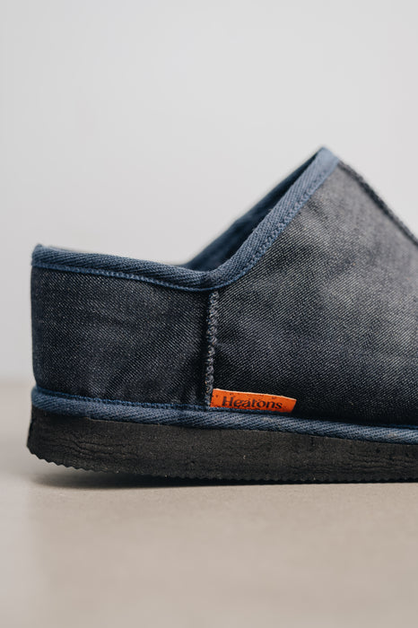 Close up of the heel of a Mens Sheepskin Slipper with Denim Exterior with orange cork Heatons brand label. for durability.