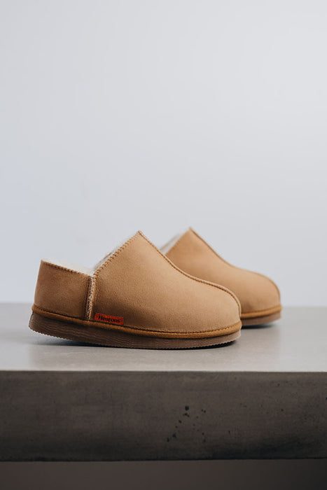 Side View of Cadi Mel Sheepskin Slippers on Concrete Surface