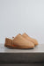 Side view of Cadi Tabac Sheepskin Slippers on Concrete Surface
