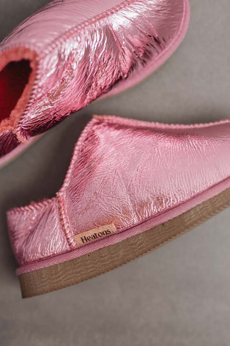 Close up View of Cadi Metallic Pink Sheepskin Slippers with Heatons label detail on Concrete Surface