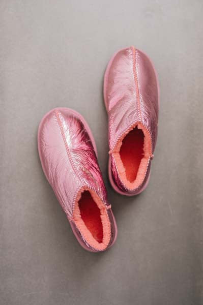 Birds Eye View of Cadi Metallic Pink Sheepskin Slippers on Concrete Surface