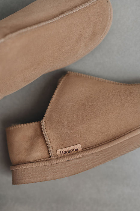 Close up View of Cadi Taupe Sheepskin Slippers with Heatons label detail on Concrete Surface