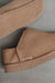Close up View of Cadi Taupe Sheepskin Slippers with Heatons label detail on Concrete Surface