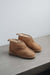 Side view of Erin women's Sheepskin Slippers in Tabac on Concrete Surface