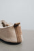 Rear view of Grace, a light soft-soled sheepskin slipper showing the detail of the suede tag and label.
