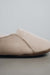 Close up view of Grace, a light soft-soled sheepskin slipper, showing the detail of the side stitching.