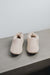 Front view of Grace, a light soft-soled sheepskin slipper in vanilla.