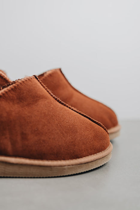 Close up of the toe post of a pair of rust coloured ankle-high sheepskin slipper (Henry)