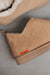 Close up of Tan coloured ankle-high sheepskin slipper with orange cork label showing the Heatons brand