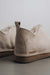 Close up of the heel of a pair of vanilla coloured ankle-high sheepskin slipper (Hetty)