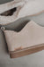 Close up of vanilla coloured ankle-high sheepskin slipper with natural cork label showing the Heatons brand